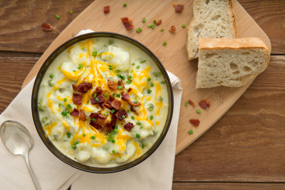 Overhead view of potato soup place setting with bread