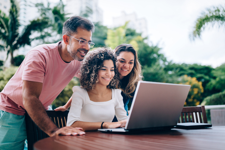 Family using laptop at resting area