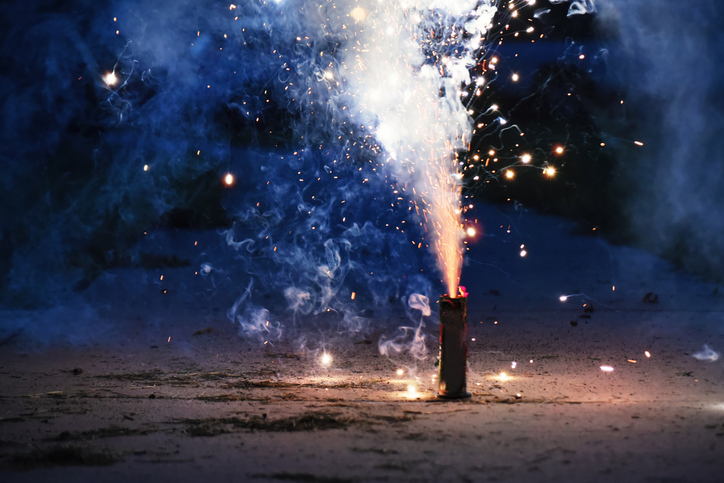 A sparkling firework display on the ground.